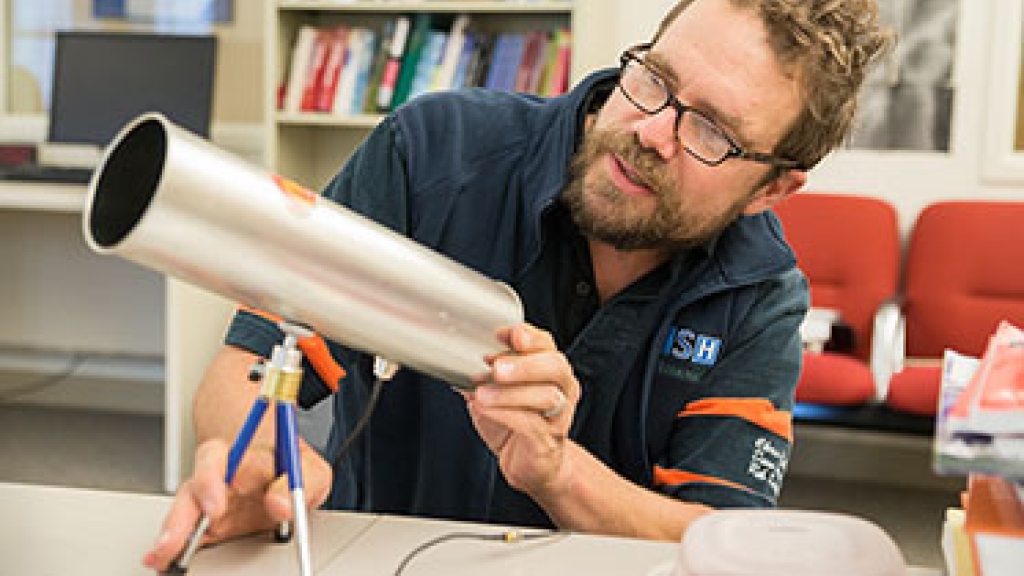 New ISTS Director Sean Smith examines a cantenna, a device used for extending or probing a wireless local area network (WLAN). (Photo by Eli Burakian ’00)