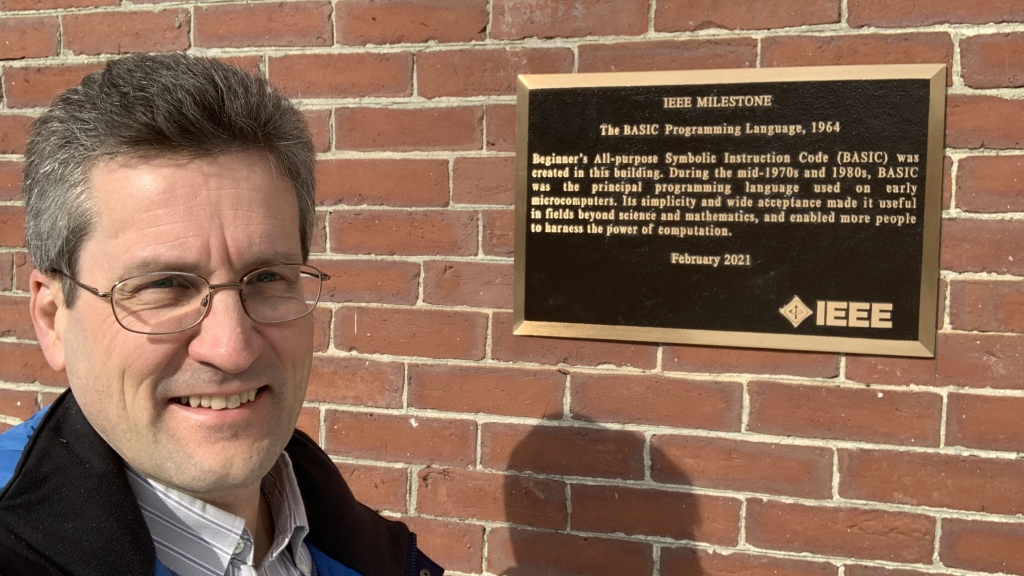David Kotz '86, the Pat and John Rosenwald Professor of Computer Science, stands next to the IEEE Milestone plaque outside the south entrance to the Collis Center after it was installed earlier this month.