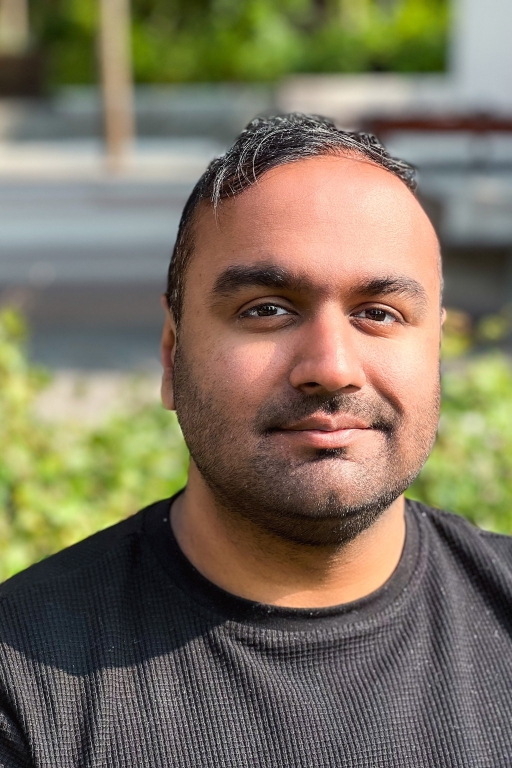Image of Nikhil Singh, close-up in front of a garden.