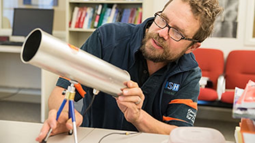 New ISTS Director Sean Smith examines a cantenna, a device used for extending or probing a wireless local area network (WLAN). (Photo by Eli Burakian ’00)