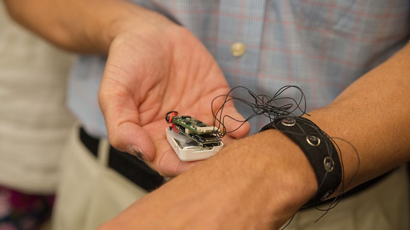 Professor David Kotz tests the prototype bioimpedance biometric bracelet.